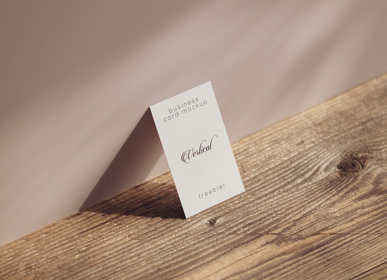A free business card by the wall mockup