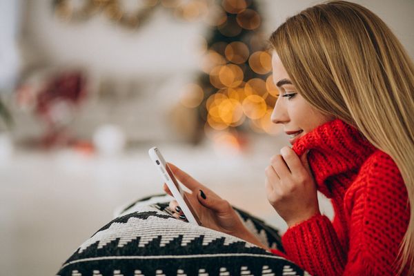 Women watching Christmas videos through smartphone